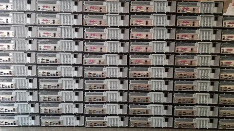 Stack of computers showing there plugs and ports Stock Photos