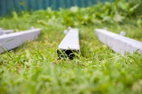 A stack of concrete beams lying on the grass. Close up macro. Stock Photos