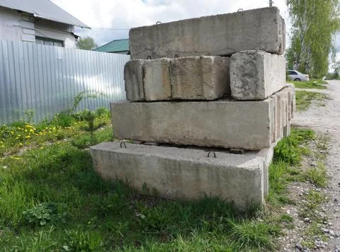 Stack of concrete blocks, construction site against a blue sky Stock Photos