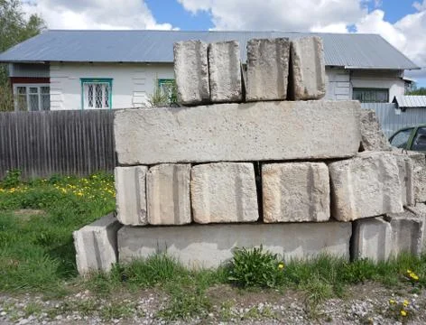 Stack of concrete blocks, construction site against a blue sky Stock Photos