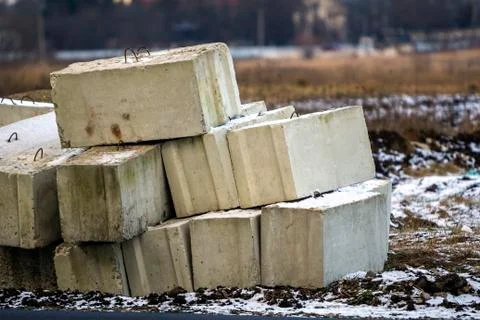 Stack of concrete blocks for foundation on construction site. Ferroconcrete r Stock Photos