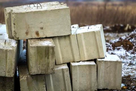 Stack of concrete blocks for foundation on construction site. Ferroconcrete r Stock Photos