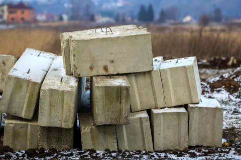 Stack of concrete blocks for foundation on construction site. Ferroconcrete r Stock Photos