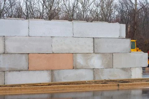 Stack of concrete blocks for foundation on construction site ferroconcrete re Stock Photos