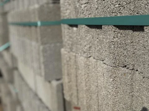 Stack of concrete blocks with green straps used in construction projects an.. Stock Photos