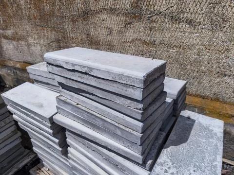 A stack of concrete blocks sitting on top of a pile of concrete Stock Photos
