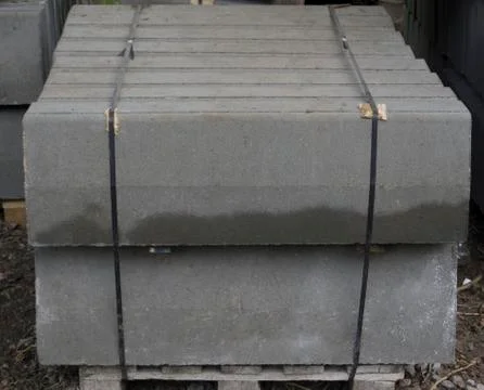 Stack of concrete curbstone. Construction process Stock Photos