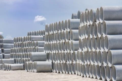 Stack of concrete drainage pipes for wells and water discharges Stock Photos