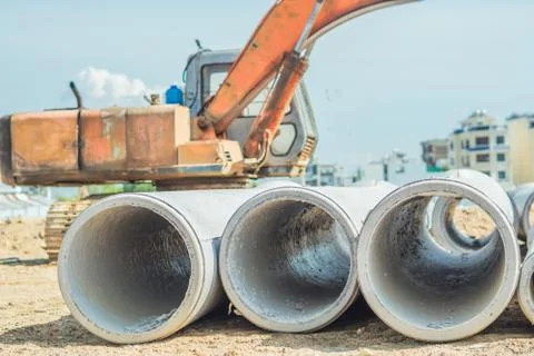 Stack of concrete drainage pipes for wells water discharges laying an external Stock Photos
