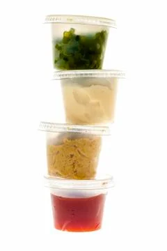 Stack of condiment containers Foto stock