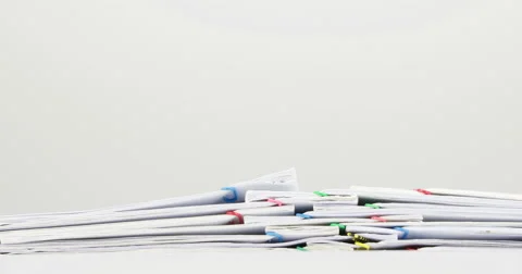 Stack confused paperwork overload on white table time lapse Stock Footage 61007212