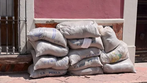 Stack Of Construction Sandbags Against Pink Colonial Wall Queretaro Mexico Stock Footage 343995767