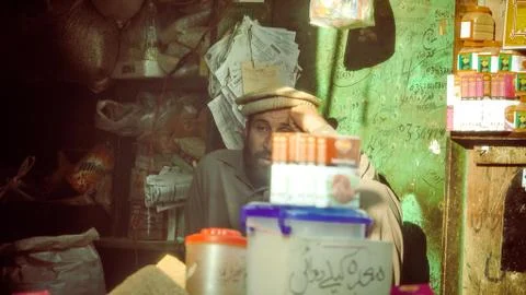 Stack of container with man behind sitting 스톡 사진