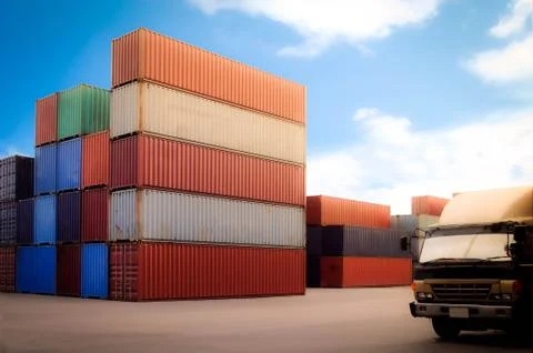 Stack of containers box in a logistic depot yard and track head without label Stock Photos