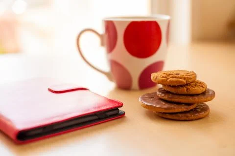 Stack of Cookies Cup and Electonic Tablet in Red Leather Case Stock Photos