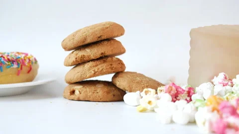 Stack of cookies , donuts and popcorn on table Stock Footage 154804793
