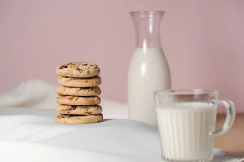 Stack of cookies next to a full glass and bottle of milk 스톡 사진