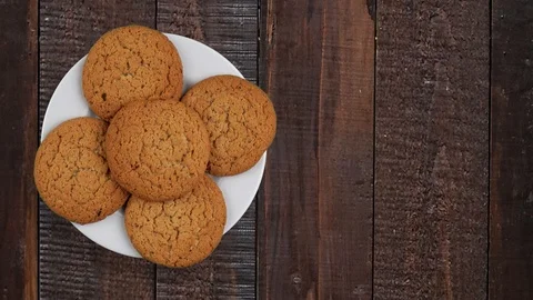 A stack of cookies rotates. A few biscuits on a rotating plate. A plate on a  Stock Footage 93435854