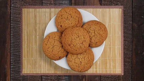 A stack of cookies rotates. A few biscuits on a rotating plate. A plate on a  Video stock 104186119