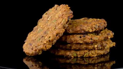 Stack of Cookies with Seeds and Chocolate Chips Rotating on Dark Background Stock Footage 330517497