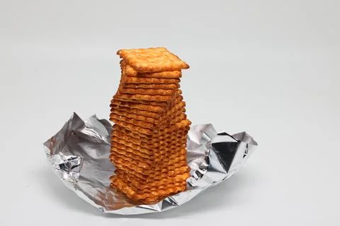 Stack of cookies on silver packaging, diet, proper nutrition, background Stock Photos