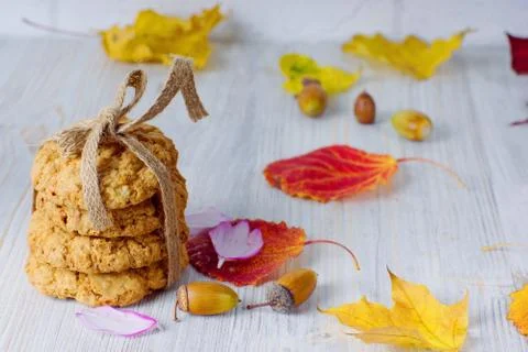 A stack of cookies tied with a rope next to autumn leaves on the table. Autum Stock Photos