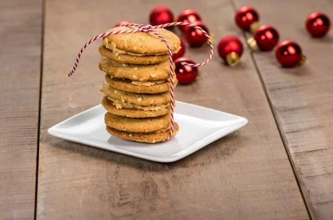 Stack of cookies on white plate with red balls Stock Photos