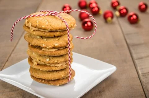 Stack of cookies on white plate with red balls Stock Photos