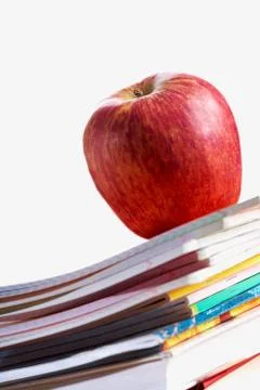 Stack of copybooks with big red apple on its top Stockfoto's