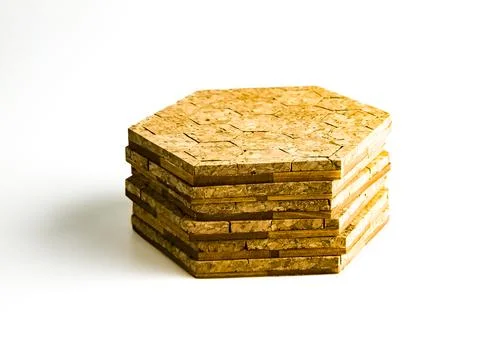 Stack of cork hot pads in hexagon shape isolated on white background Stock Photos