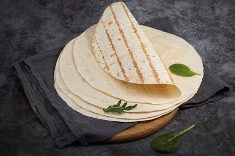 Stack of corn tortillas on dark background. Mexican food Stock Photos