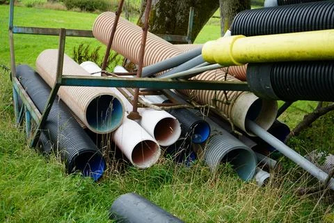 Stack of corrugated plastic drainage pipes on rusty frame in Crich Derbyshire Stock Photos