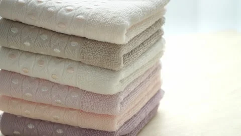 Stack of cotton terry clean folded towels rotate on board. Stock Footage 138443477