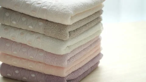 Stack of cotton terry folded towels rotate on board. Health, hygiene concept. Stock Footage 139285400