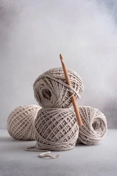 Stack of cotton threads pastel color skeins and wooden hook for craft and han Stock Photos