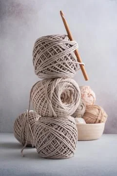 Stack of cotton threads pastel color skeins and wooden hook for craft and han Stock Photos