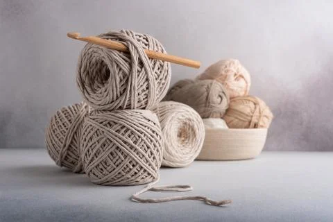 Stack of cotton threads pastel color skeins and wooden hook for craft and han Stock Photos