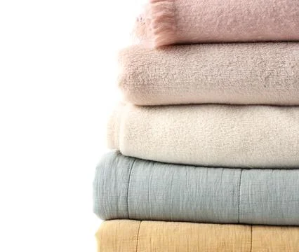 Stack of cozy blankets on white background, closeup Fotos de archivo