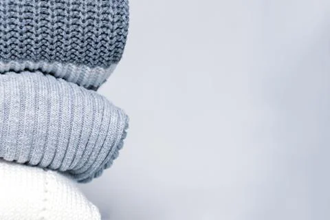 Stack of cozy comfortable homely clean washed knitted sweaters in pastel colo Stock Photos