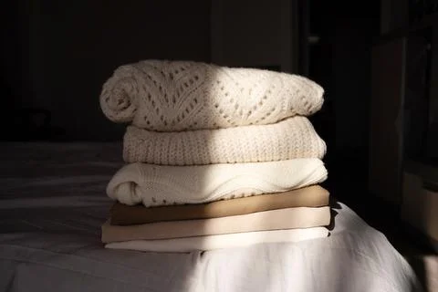 Stack of Cozy Knit Sweaters in Natural Light Stock Photos