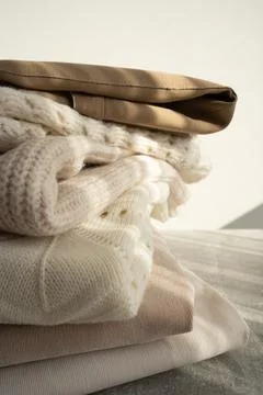 Stack of Cozy Knit Sweaters in Natural Light Stock Photos