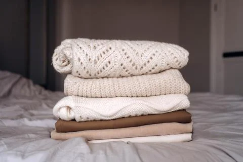Stack of Cozy Knit Sweaters in Natural Light Stock Photos