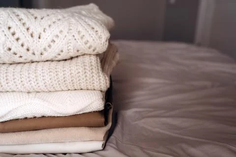 Stack of Cozy Knit Sweaters in Natural Light Stock Photos