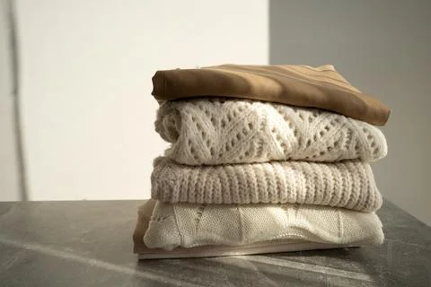 Stack of Cozy Knit Sweaters in Natural Light Stock Photos