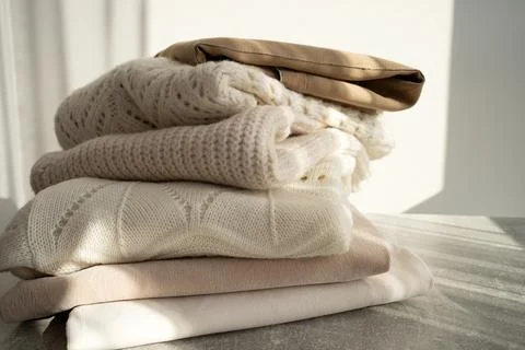 Stack of Cozy Knit Sweaters in Natural Light Stock Photos