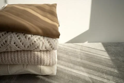 Stack of Cozy Knit Sweaters in Natural Light Stock Photos