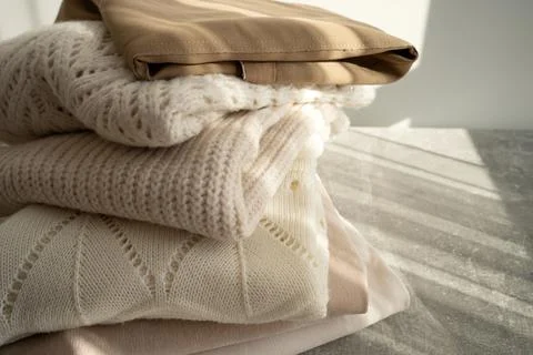 Stack of Cozy Knit Sweaters in Natural Light Stock Photos