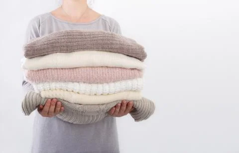 Stack of cozy knitted sweaters Stock Photos