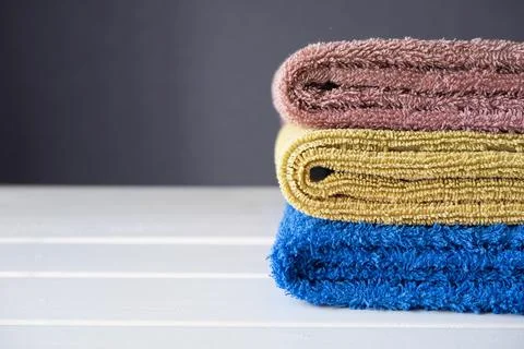 Stack of cozy knitted sweaters on white background. Stock Photos