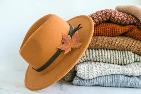 Stack of cozy knitted warm sweater with Autumn fall maple leaf and beige styl 스톡 사진